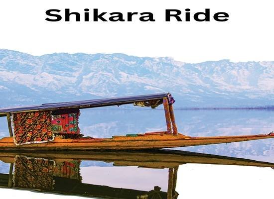 Shikara on Dal Lake with blooming lotus flowers in summer